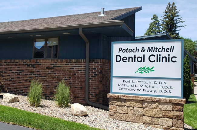 Potach & Mitchell Dental Clinic brick building exterior with signage and landscaping